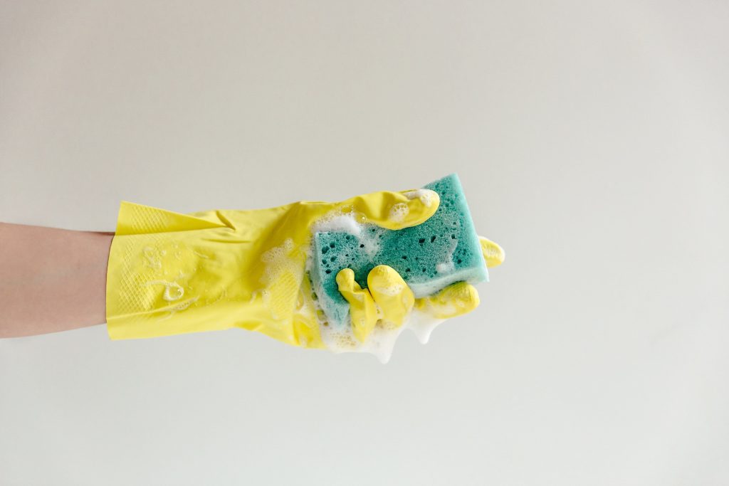Holding a Sponge with a Yellow Glove